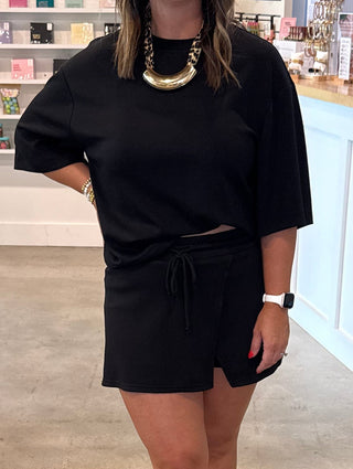 Woman in a black matching skort set