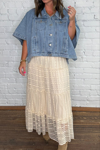 Denim shirt and a long cream-colored lace tiered skirt with boots.
