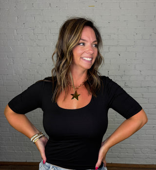 Women wearing a black double layer short sleeve top.