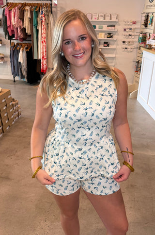 White matching set with blue floral and green details