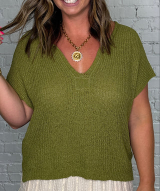 Short-sleeve olive green knit top.