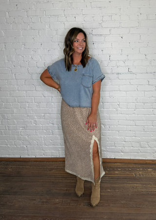 Chambray short-sleeve top and a brown and purple floral midi skirt with a white lace and boots.