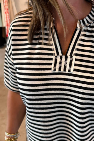 Woman wearing a black and white striped outfit 