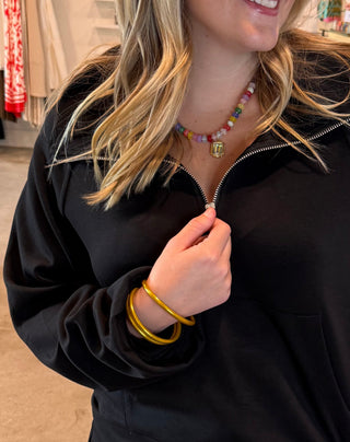 Woman in a black quarter zip top