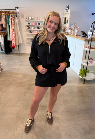 Woman in a black skort outfit 