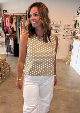 Taupe and white polka dot top with white jeans