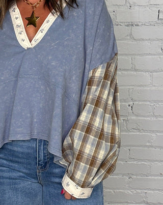 sleeve details of a mineral washed long sleeve plaid top with floral cuff and collar.