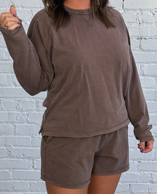 Women wearing a casual brown matching set with butter yellow tennis shoes.