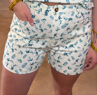 Person wearing a matching sleeveless top and shorts set with blue animal pattern in a store setting.