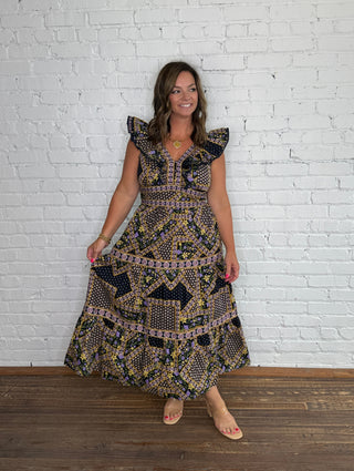 Short sleeve midi dress with pockets featuring a navy, purple, orange, green and yellow geometric pattern.
