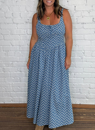 Sleeveless blue and white embroidered chevron-patterned midi dress.