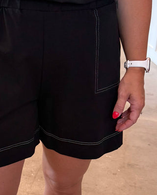Person wearing black shorts