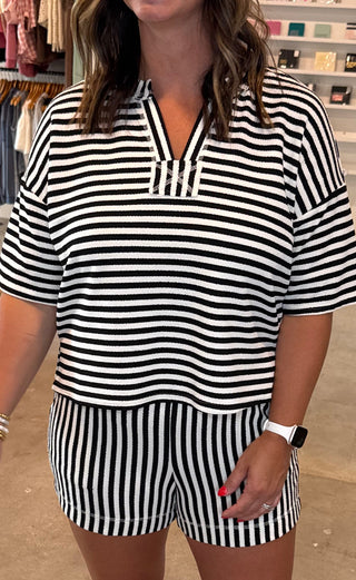 Woman wearing a black and white striped outfit 