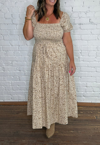 Beige and brown floral midi dress with puff sleeves.