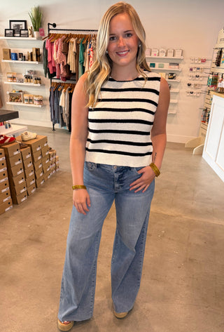 Person wearing a striped shirt and jeans