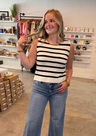 Cream and black striped top with black bows in the back