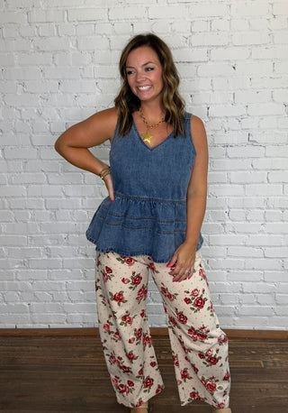 Blue denim peplum tank top and cream wide-leg pants with a red floral pattern.