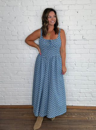 Sleeveless blue and white embroidered chevron-patterned maxi dress with pockets.